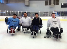 With the local ice sled hockey team